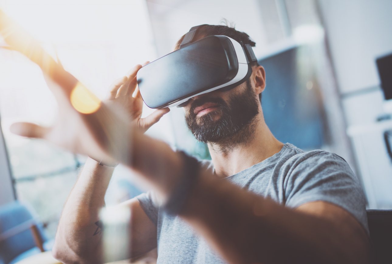 event marketing: man looking through virtual reality glasses at interactive event